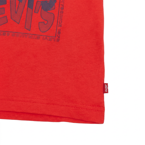 Close-up of the hem and red brand label on a pure white background