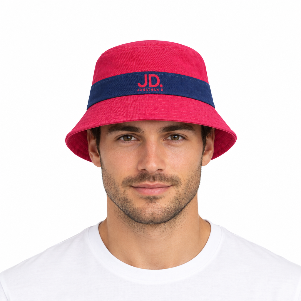 Male model wearing the Jonathan D red and navy bucket hat against a white studio background