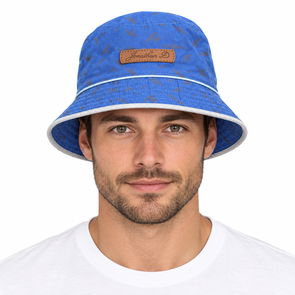 Model wearing Jonathan D bucket hat blue bird-patterned side on white background