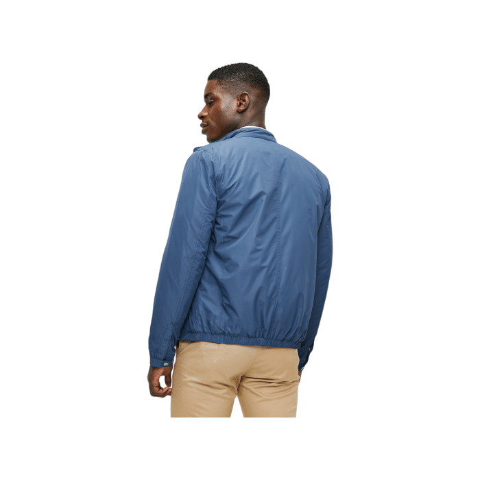 702 25A | The Polo Jackets Men's LS Tech Puffer Harrington in Blue combines classic style with modern functionality. Featuring a lightweight, insulated design and a water-resistant outer shell, this jacket offers warmth and protection while maintaining a sleek, sophisticated look.