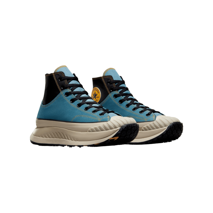 133 156B | The Converse Chuck 70 AT-CX Hi in Noble Blue-Black-Yellow reimagines a timeless classic with bold, contemporary updates. With a striking noble blue upper, contrasting black details, and vibrant yellow accents, this high-top sneaker delivers a perfect blend of vintage charm and modern comfort.