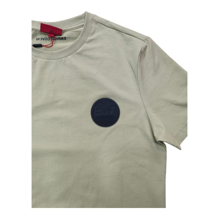 559 138 C | The <strong>Enrico Coveri T-shirt Rubber Logo in Light Green</strong> combines modern style and comfort with its soft, breathable cotton blend and eye-catching raised rubber logo on the chest, adding a bold yet sophisticated touch to any casual outfit. The light green color offers a fresh, versatile hue that complements various looks, whether you're pairing it with jeans, shorts, or chinos for a smart-casual or relaxed ensemble. With its durable, high-quality fabric and well-crafted design, this t-shirt not only retains its shape after multiple washes but also ensures long-lasting comfort and style for everyday wear.