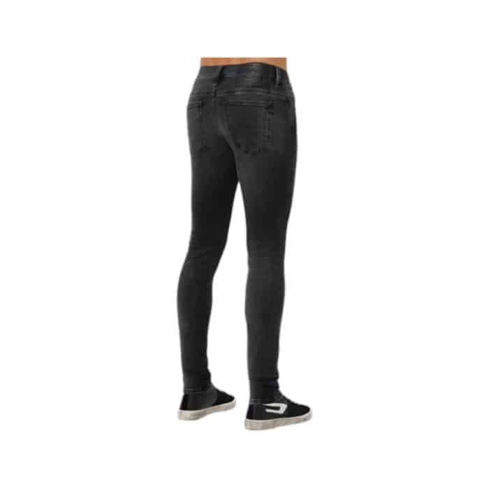 866 3 C | The <em>Diesel Jeans Skinny D-Istort-X Faded Black</em> features a sleek, body-hugging fit that tapers from the waist to the ankle, offering a modern silhouette while ensuring flexibility and comfort through its high-quality stretch denim. The faded black wash adds a rebellious, worn-in look that effortlessly transitions from casual daytime outfits to edgy evening ensembles, pairing well with a variety of tops and accessories for versatile styling. Thoughtfully designed with details such as reinforced stitching, branded metal hardware, and Diesel’s iconic logo patch on the back waistband, these jeans combine durability and fashion-forward style for everyday wear.