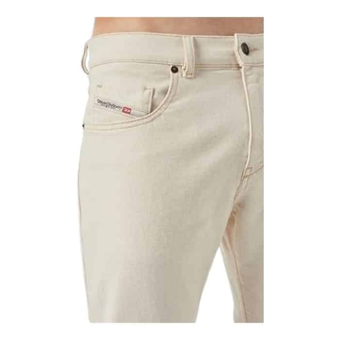 867 6 C | The Diesel Jeans D-Strukt Tapered Cream White offers a fresh and stylish twist on classic denim, making it an essential addition to any modern wardrobe. Crafted from high-quality cotton, these jeans feature a tapered fit that flatters the thighs while narrowing down towards the ankles, providing a sleek silhouette that is both comfortable and versatile. The soft cream white color adds a unique touch, allowing for effortless pairing with a variety of tops and accessories, whether you're aiming for a casual daytime look or a more polished evening ensemble.