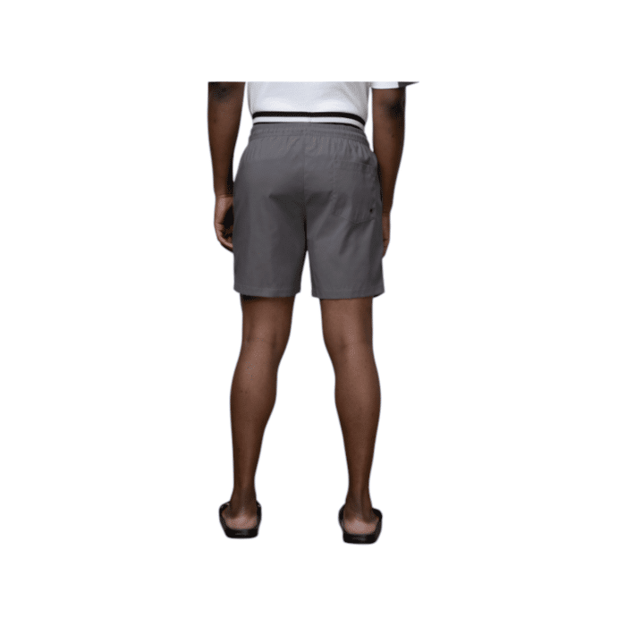 918 10A | The Polo Sports Monogram Beach Shorts in Grey offer a sleek and understated design with a plain pink exterior, featuring a subtle Polo logo on the left bottom side. However, when wet, these innovative shorts reveal a hidden darker grey monogram pattern across the fabric, transforming their look into something dynamic and eye-catching. Perfect for beach days, these stylish and functional shorts blend simplicity with a surprising twist, making them an ideal choice for those who love a mix of classic and modern fashion elements.