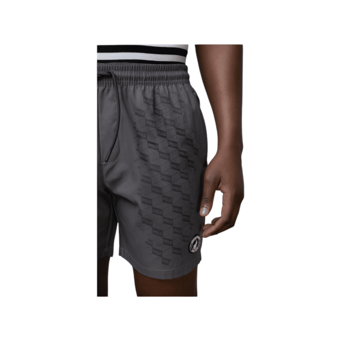 918 10D | The Polo Sports Monogram Beach Shorts in Grey offer a sleek and understated design with a plain pink exterior, featuring a subtle Polo logo on the left bottom side. However, when wet, these innovative shorts reveal a hidden darker grey monogram pattern across the fabric, transforming their look into something dynamic and eye-catching. Perfect for beach days, these stylish and functional shorts blend simplicity with a surprising twist, making them an ideal choice for those who love a mix of classic and modern fashion elements.