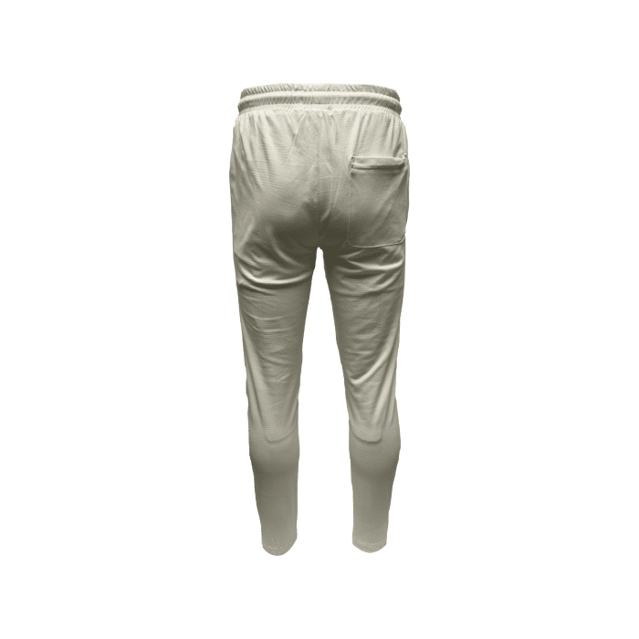 952 4D | The <em>Vialli Tracksuit Impress</em> in Cream combines modern style with everyday comfort, crafted from a soft and durable cotton-polyester blend. Featuring a short-sleeved t-shirt and tapered pants, this tracksuit offers a relaxed yet tailored fit, making it perfect for casual outings or laid-back lounging while keeping you effortlessly stylish.