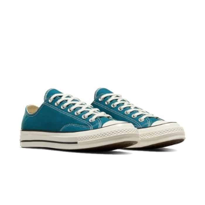 126 83 B | The Converse Chuck 70 Low OX in Teal Universe/Egret/Black effortlessly merges vintage-inspired design with modern comfort and durability, making it a standout addition to any footwear collection. Crafted with premium 12-ounce canvas and a sleek teal upper accented by egret and black details, this sneaker offers a versatile yet bold aesthetic that enhances both casual and elevated outfits. Enhanced by a cushioned OrthoLite insole, a glossy rubber sidewall, and reinforced stitching, it provides exceptional all-day support while maintaining timeless style and authenticity.