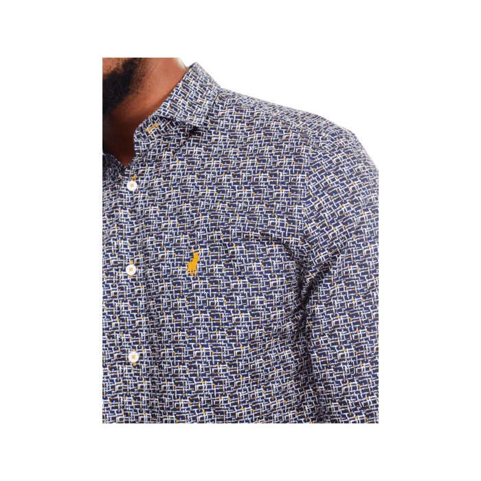 299 94B | The Polo Geo Printed LS Navy combines timeless sophistication with a modern geometric design, making it a standout piece for versatile styling. Crafted from high-quality fabric, this long-sleeved shirt offers a soft, breathable feel and a tailored fit that enhances your silhouette for a polished look. The rich navy color serves as the perfect backdrop for the intricate geo print, creating a balance of elegance and contemporary flair that transitions effortlessly from casual outings to formal occasions.