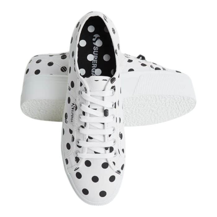 556 4 B | The Superga 2790 Polkadots White-Black combines playful charm with modern sophistication, featuring a bold black-and-white polka dot design that effortlessly elevates casual and chic outfits alike. Its 1.5-inch platform sole adds a subtle height boost while providing comfort and stability, making it perfect for all-day wear. Crafted with breathable cotton canvas and a durable rubber sole, this versatile sneaker ensures long-lasting style and functionality for any occasion.