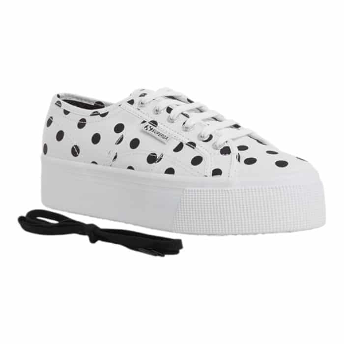 556 4 C | The Superga 2790 Polkadots White-Black combines playful charm with modern sophistication, featuring a bold black-and-white polka dot design that effortlessly elevates casual and chic outfits alike. Its 1.5-inch platform sole adds a subtle height boost while providing comfort and stability, making it perfect for all-day wear. Crafted with breathable cotton canvas and a durable rubber sole, this versatile sneaker ensures long-lasting style and functionality for any occasion.