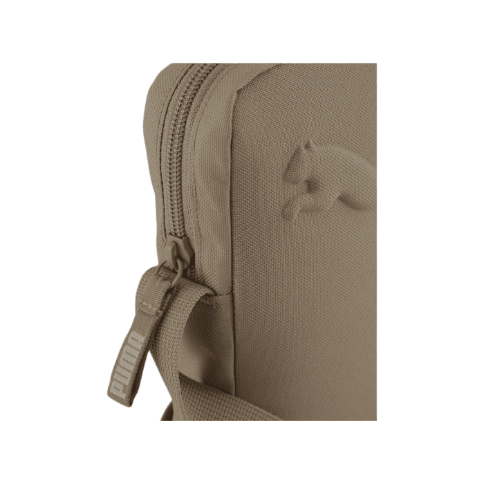 171 71B | The Puma Buzz Portable Bag Bold - Taupe is a sleek and durable everyday bag with an embossed Puma logo, adjustable strap, and multiple compartments for easy organization and versatile wear.