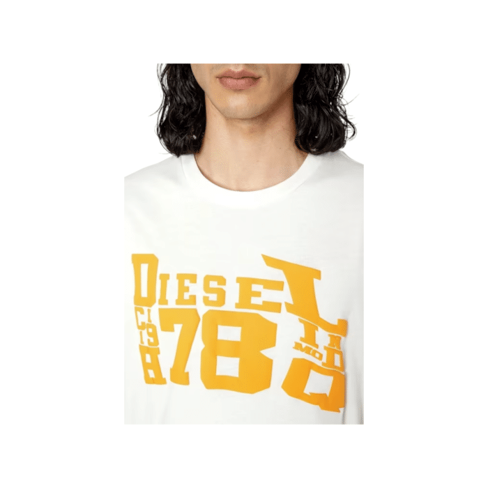 862 46 D | The Diesel T-Shirt T-Diegor G7 White/Orange combines bold design with premium comfort, making it a standout piece in any casual wardrobe. Crafted from 100% soft cotton, it features a tailored fit, a classic crew neck, and vibrant orange accents that pop against the crisp white base, delivering a modern and edgy look. Perfect for effortless styling, this versatile T-shirt transitions seamlessly from casual outings to relaxed social settings, ensuring both durability and timeless appeal