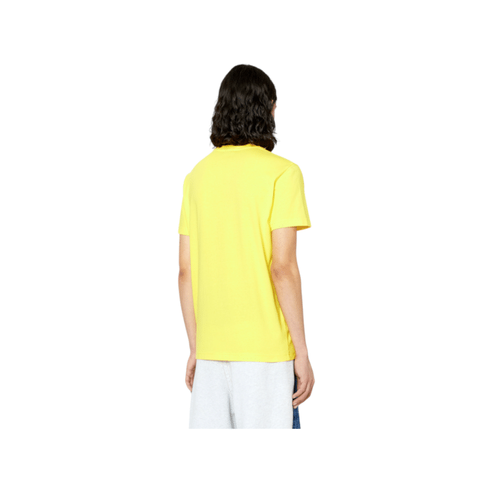 862 54 A | The Diesel T-Shirt T-Diegor K61 Yellow is a bold and stylish piece that combines modern design with exceptional comfort, featuring a slim-fit silhouette and a ribbed crew neck for a sleek yet relaxed look. Made from 100% soft cotton, this vibrant yellow t-shirt offers breathable comfort and long-lasting durability, with fabric that resists fading and retains its brightness after repeated washes. Perfect for making a statement, it pairs effortlessly with jeans, cargo pants, or chinos, making it a versatile staple for casual outings or edgy streetwear-inspired ensembles.