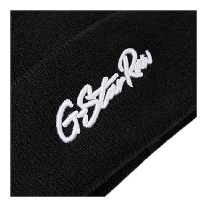 1002 2 B | The G-Star Effo Beanie Artwork Long in Black is a stylish and versatile accessory designed to provide both warmth and a contemporary edge, featuring a rib-knit construction that ensures a snug yet comfortable fit while allowing for different styling options, whether worn slouchy or folded for a more structured look. Made from a high-quality blend of 55% recycled polyester and 45% acrylic, this beanie offers durability, softness, and breathability, making it a perfect year-round essential for casual and streetwear outfits. With a bold 3D ‘RAW’ embroidery at the front and a subtle woven G-Star Originals label at the back, this sleek black beanie exudes urban sophistication while maintaining the brand’s signature aesthetic of modern minimalism and premium craftsmanship.