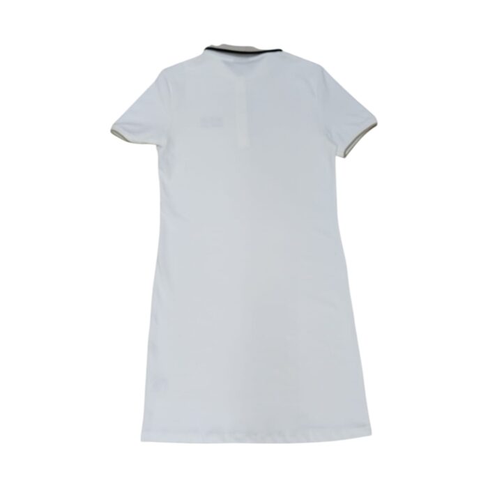 1014 6 B | The Polo Golfer Dress Macey Tipped Off White is a timeless blend of sporty elegance and refined sophistication, featuring a classic polo silhouette with contrast tipping along the collar and sleeve edges for a polished yet effortless look. Crafted from a high-quality cotton blend, this dress offers exceptional comfort with a soft, breathable feel and just the right amount of stretch, ensuring ease of movement while maintaining a flattering, tailored fit suitable for various occasions. Whether paired with sneakers for a casual day out or dressed up with loafers and a blazer for a chic, business-casual ensemble, this versatile piece is designed for durability, retaining its pristine appearance and impeccable craftsmanship even after multiple wears and washes.