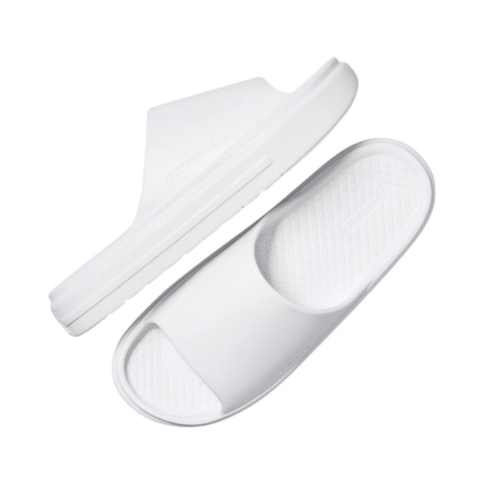 125 48 B | The Converse Essential Slide Slip White offers a sleek and minimalist design, featuring a clean white colorway and a wide, comfortable strap adorned with the iconic Converse logo, making it a versatile addition to any casual or semi-formal outfit. Crafted with a cushioned footbed for superior comfort and a durable synthetic upper, these slides provide excellent support and grip, ensuring stability and long-lasting wear for everyday activities. Easy to maintain and effortlessly stylish, this slide is the perfect combination of practicality and timeless design, making it an essential choice for those who value comfort and classic aesthetics.