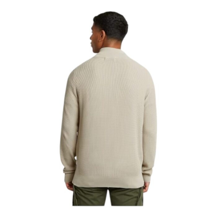 144 25 B | The G-Star RAW Knitted Zip Serrated Sweater in Serrated Stone is a stylish and versatile piece that blends modern aesthetics with superior comfort, featuring a high-quality knitted fabric that offers warmth while maintaining breathability for all-day wear. Designed with a raised collar and a sleek zipper closure, this sweater allows for adjustable styling and protection against the elements, making it a perfect layering option for transitional weather. With its neutral Serrated Stone hue and subtle serrated detailing, this piece effortlessly complements a variety of outfits, ensuring a refined yet contemporary look for any occasion.