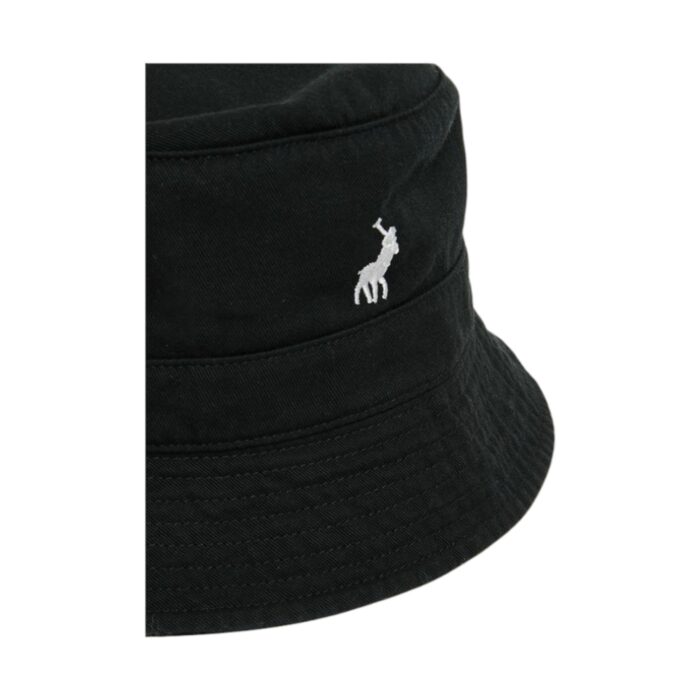 319 21 A 1 | The Polo Sydney Twill Bucket Hat in Black is a stylish and versatile accessory designed for both comfort and fashion. Made from high-quality twill fabric, this hat offers durability, breathability, and a soft, flexible fit. Its classic bucket silhouette, combined with a sleek black hue, ensures effortless pairing with any outfit. The subtle Polo branding adds a touch of sophistication, making it a timeless wardrobe staple. Featuring a wide brim for sun protection and a packable design for convenience, this unisex hat is perfect for everyday wear, travel, or outdoor adventures. Stay effortlessly cool with this must-have fashion essential.