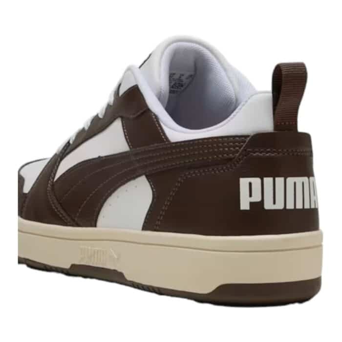 5 196 D | The Puma Rebound V6 Low in White/Chocolate/Alpine Snow combines classic basketball-inspired design with modern comfort, featuring a durable synthetic leather upper accented with rich suede overlays for a premium look and feel. Its cushioned SoftFoam+ insole provides all-day comfort, while the sturdy rubber outsole ensures excellent grip and traction, making it perfect for both casual wear and light athletic activities. With a sleek low-cut silhouette and a timeless color palette, this sneaker effortlessly blends retro vibes with contemporary street style, making it a must-have for sneaker enthusiasts.